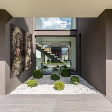 Exterior of  modern grey villa with terrace and green plants