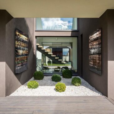 Exterior of  modern grey villa with terrace and green plants