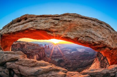 Work on the wall of Mesa Arch in Utah